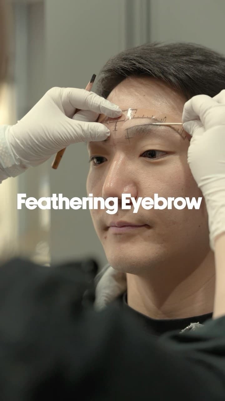 Permanent makeup Toronto — PMU artist mapping brows during a feathering eyebrow treatment at The Black Light